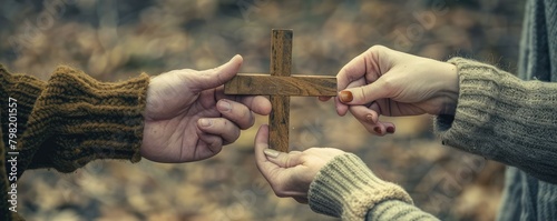 Hand passing wooden cross to another. banner photo