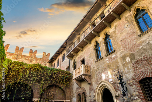 View of Juliet's balcony and house, a Gothic-style 1300s house and museum, with a stone balcony, said to have inspired Shakespeare, in Verona, Italy.	 photo