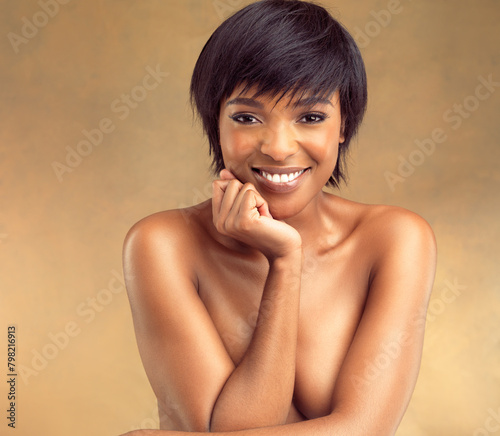 Cosmetics, skincare and portrait of black woman with confidence, smile and natural makeup in studio. Dermatology, beauty and happy girl with facial care, skin glow and pride on brown background