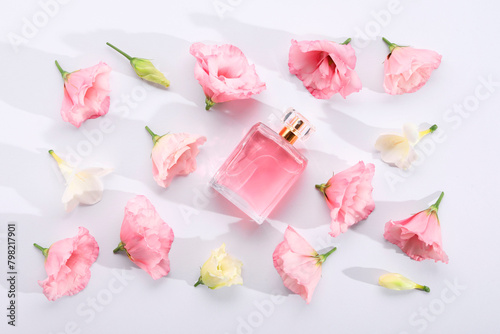 Luxury perfume and floral decor on white background  flat lay