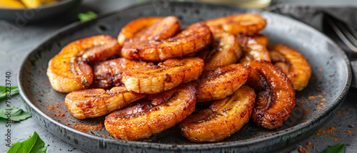 Homemade fried bananas with cinnamon in a gray