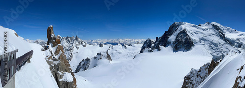 Haute-Savoie, France, 04-25-2024: panoramic view from L’Aiguille du Midi (Needle at midday), the highest spire (3.842 m) of the Aiguilles de Chamonix, with Mont Blanc massif peaks and the italian Alps photo