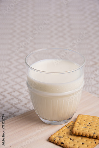 Cow's milk with a glass glass on a light background