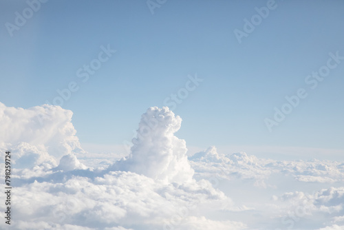 Sunrise above textured clouds from airplane window