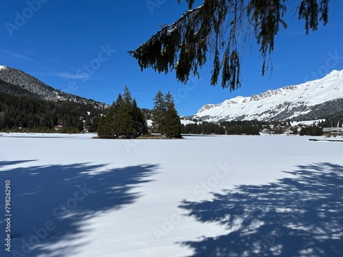 A typical winter idyll on the frozen and snow-covered alpine lake Heidsee (Igl Lai) in the Swiss winter resorts of Valbella and Lenzerheide - Canton of Grisons, Switzerland (Schweiz) photo