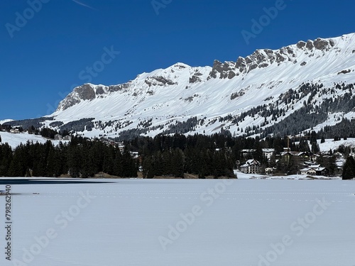 A typical winter idyll on the frozen and snow-covered alpine lake Heidsee (Igl Lai) in the Swiss winter resorts of Valbella and Lenzerheide - Canton of Grisons, Switzerland (Schweiz) photo