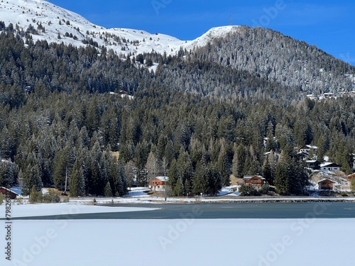 A typical winter idyll on the frozen and snow-covered alpine lake Heidsee (Igl Lai) in the Swiss winter resorts of Valbella and Lenzerheide - Canton of Grisons, Switzerland (Schweiz) photo