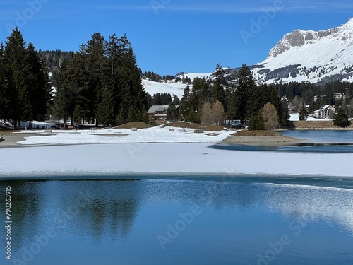 A typical winter idyll on the frozen and snow-covered alpine lake Heidsee (Igl Lai) in the Swiss winter resorts of Valbella and Lenzerheide - Canton of Grisons, Switzerland (Schweiz)