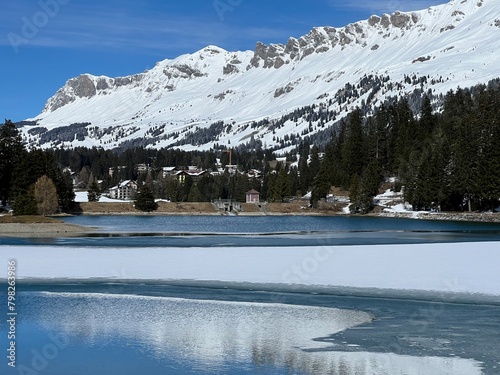 A typical winter idyll on the frozen and snow-covered alpine lake Heidsee (Igl Lai) in the Swiss winter resorts of Valbella and Lenzerheide - Canton of Grisons, Switzerland (Schweiz) photo