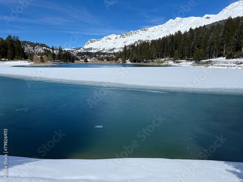 A typical winter idyll on the frozen and snow-covered alpine lake Heidsee (Igl Lai) in the Swiss winter resorts of Valbella and Lenzerheide - Canton of Grisons, Switzerland (Schweiz) photo