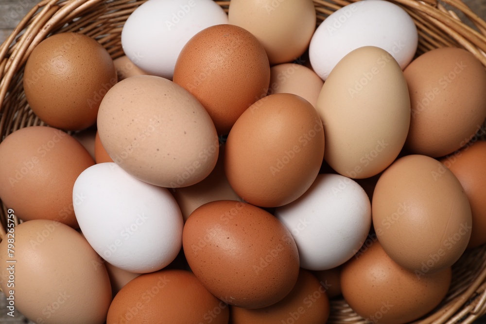 Fresh chicken eggs in wicker basket, top view Fresh chicken eggs in wicker basket, top view