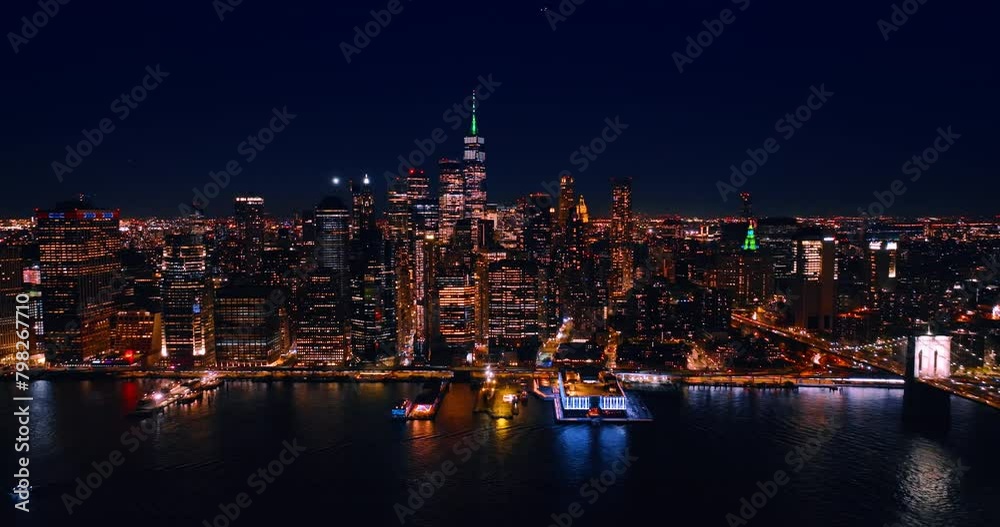 Distancing from a spectacular view of New York, the USA on the waterfront of the East River. Skyline of metropolis at night. Aerial perspective. Distancing from a spectacular view of New York, the USA on the waterfront of the East River. Skyline of metropolis at night. Aerial perspective.