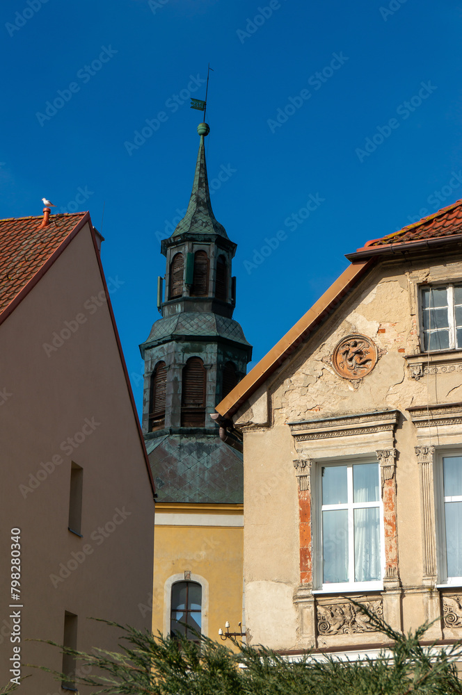Tower of historic baroque Church of the Assumption of the Blessed Virgin Mary (Kościół Wniebowzięcia Najświętszej Maryi Panny) in background. Kamien Pomorski, Poland.