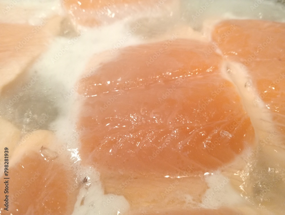 Fototapeta premium salmon steak cooking in a pan