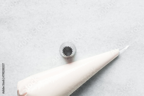 Buttercream in a piping bag with piping nozzle tip, American buttercream in a piping bag for icing cake, frosting for decorating cake