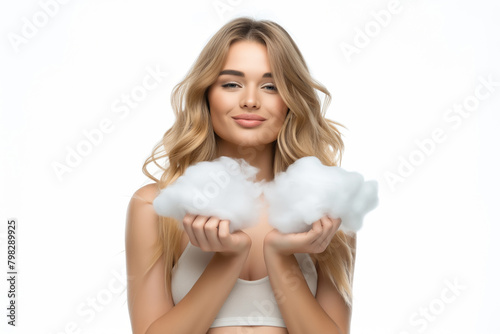 Young beautiful woman in a small top holding a cloud in her hands, on a white background photo