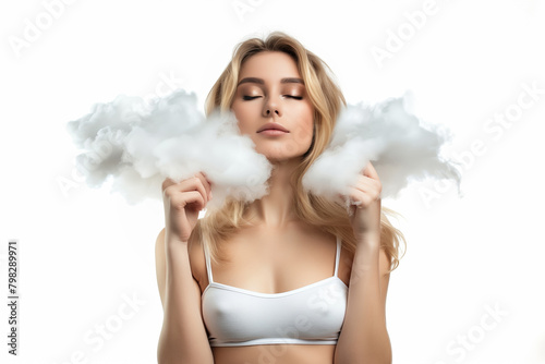 Young beautiful woman in a small top holding a cloud and dreaming with closed eyes, on a white background photo