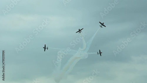 Pilots perform aerobatic stunts in the sky, executing dizzying maneuvers
