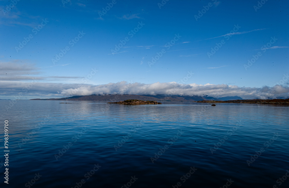 Blue Ocean scene with clear sky. Isle of Skye Scotland UK. Winter coastal landscape. Cold water