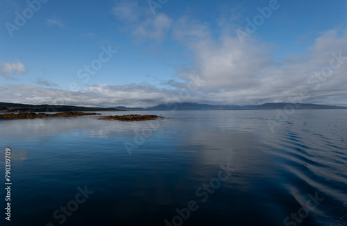 Blue Ocean scene with clear sky. Isle of Skye Scotland UK. Winter coastal landscape. Cold water