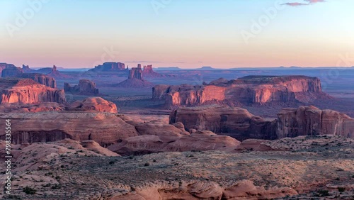 Sunrise over famous Hunts Mesa in Monument Valley shows the ruggedness and desert shapes where may old western movies were filmed