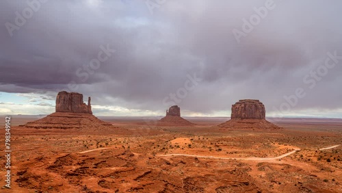 Dramatic time lapse of storm clouds moving through Monument Valley, casting a moody, dark ambiance over a famous Navajo historic site