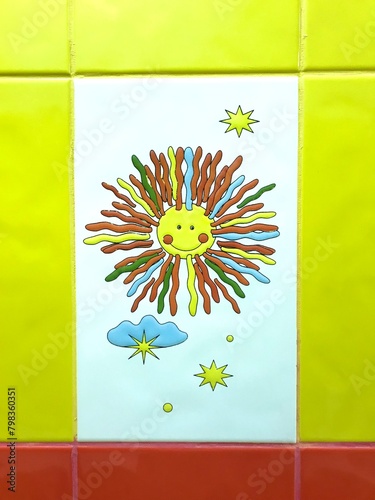 Artistic painting of a sun with colorful petals on a symmetrical tile wall