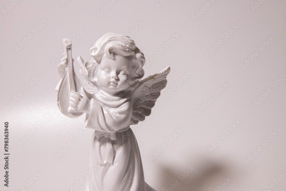 Obraz premium Sad guardian angel sculpture with open long wings across