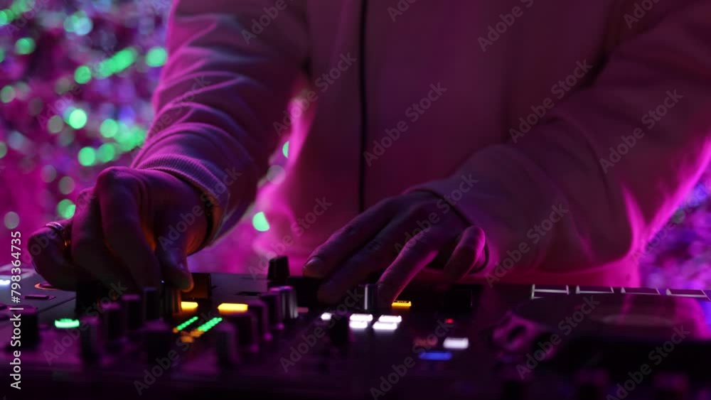 control DJ for mixing music with blurred people dancing at party in nightclub. control DJ for mixing music with blurred people dancing at party in nightclub.