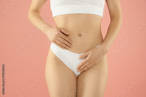 Gynecology. Woman in underwear on pink background, closeup © New Africa