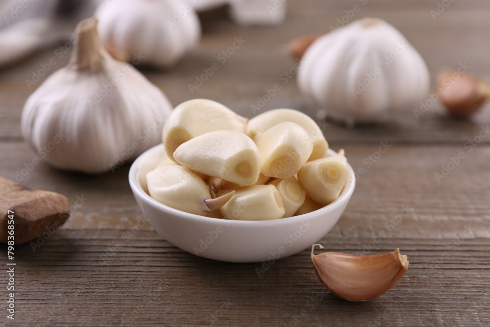 Aromatic garlic cloves and bulbs on wooden table, closeup Aromatic garlic cloves and bulbs on wooden table, closeup