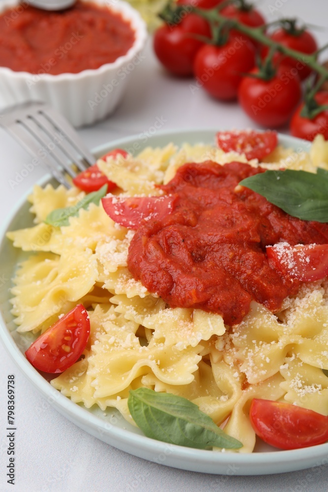 Tasty pasta with tomato sauce, cheese and basil on white table, closeup Tasty pasta with tomato sauce, cheese and basil on white table, closeup