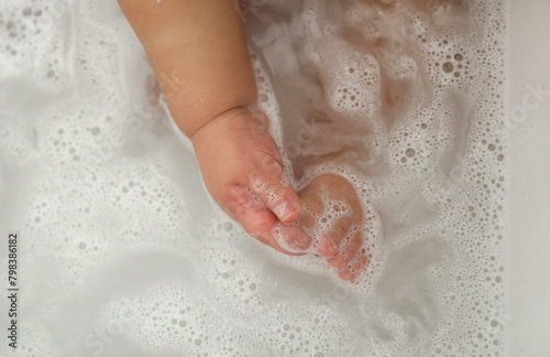 baby taking a bath, baby's toes, baby's hands in bubbles
