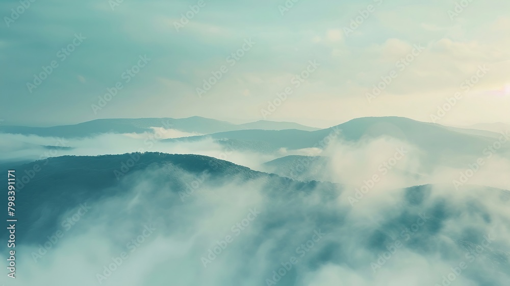 Misty horizons on a mountain top, the early morning fog softening the view, mysterious and inviting
