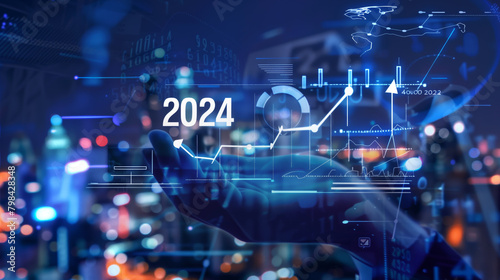 Businessman hand holding white hologram of text "2024" and icons arrow up with graph chart growth in business strategy plan for success concept on virtual screen background at night cityscape © Glebstock