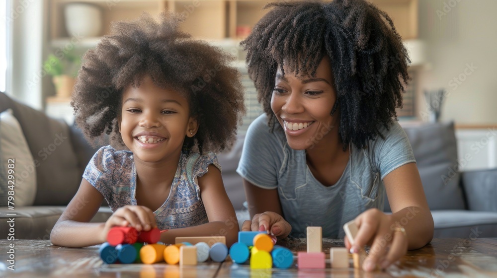 Mother and daughter are building blocks indoors Mother and daughter are building blocks indoors