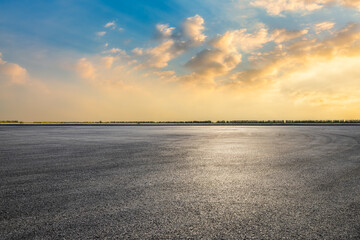 Asphalt road square with sky clouds background at dusk
