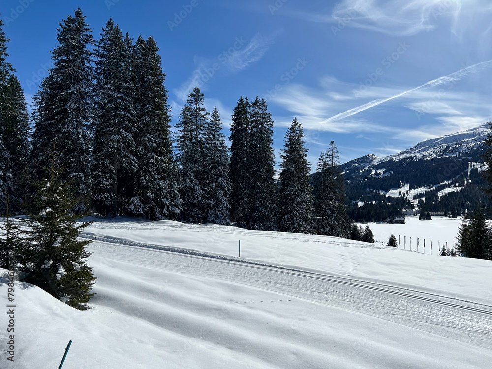 A winter sport cross-country ski trail around a frozen alpine Heidsee lake (Igl Lai lake) in the Swiss winter resorts of Valbella and Lenzerheide - Canton of Grisons, Switzerland (Schweiz)