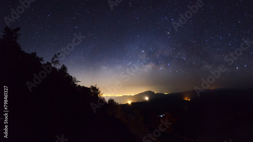 Panorama silhouette tree on high mountain with milky way galaxy, Night starry sky with stars