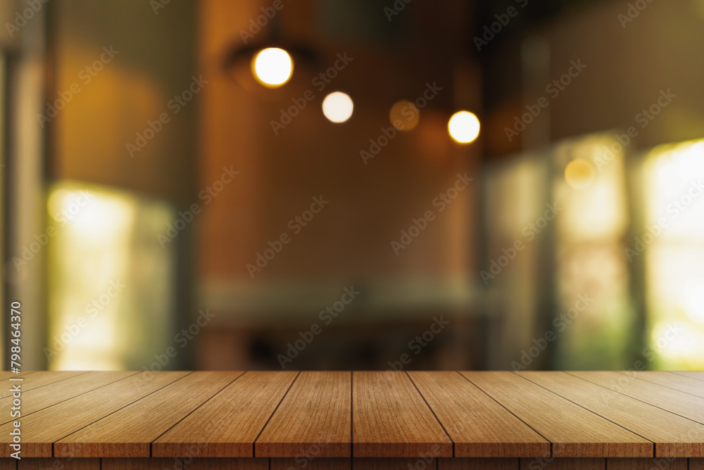 Empty wooden table top with lights bokeh on blur restaurant background. Empty wooden table top with lights bokeh on blur restaurant background.