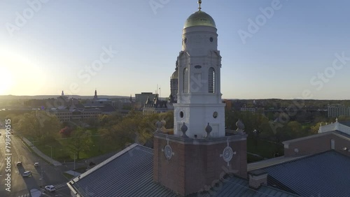Connecticut State Capitol Building - Aerial drone video orbiting left around the Connecticut Statehouse in Hartford at sunset in early spring with tower in foreground photo