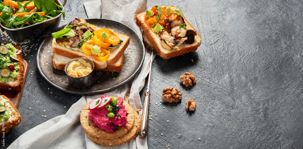 Vegan toast with avocado,mushroom and fresh salad on dark background. Vegetarian food concept Vegan toast with avocado,mushroom and fresh salad on dark background. Vegetarian food concept