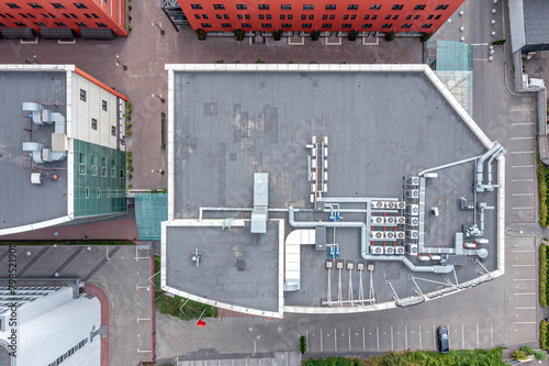 roof of a small office building with efficient ventilation system and air conditioning equipment. aerial top view.