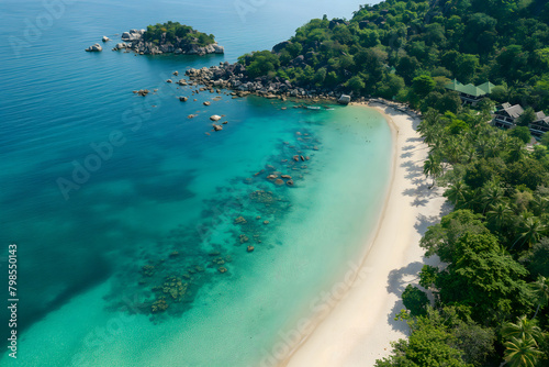 Aerial view of sandy beach with clear blue water