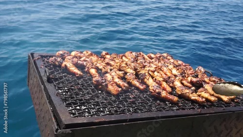 Grilling chicken with the backdrop of the Red Sea in Jordan. photo