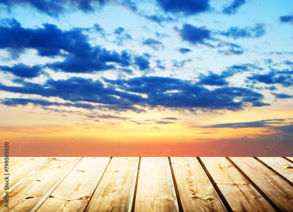 Wooden table on sky background and sunset light Wooden table on sky background and sunset light