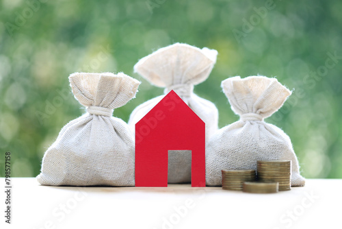 Finance, Model house with money bag on natural green background,Business investment and Save money for prepare in future concept photo