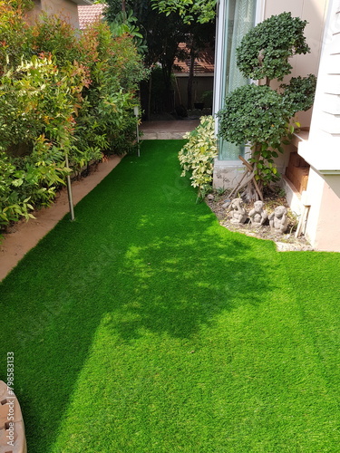Photos A backyard with green artificial grass fills most of the frame