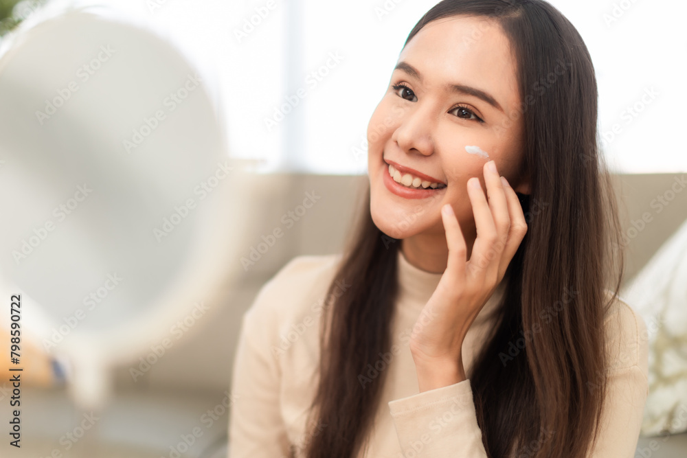 Young Asian woman doing skin care spending time at home . Young Asian woman doing skin care spending time at home .