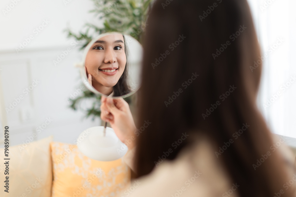 Young Asian woman doing skin care spending time at home . Young Asian woman doing skin care spending time at home .